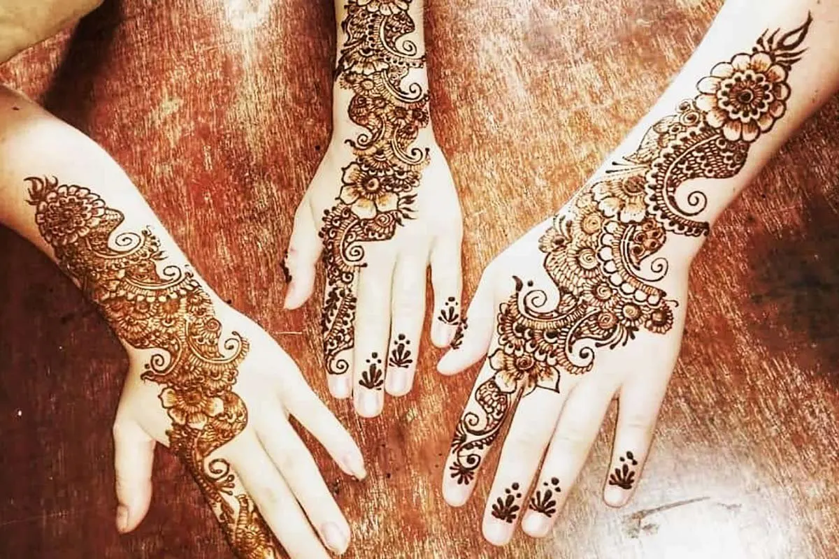 Hands decorated with intricate henna designs